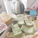  ??  ?? CRIME SCENE. Some of the equipment and cash recovered after police raided two houses in Kibler Park and Forest Hill, south of Joburg, yesterday.