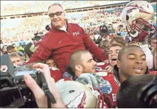  ?? Stephen M. Dowell/Orlando Sentinel/TNS ?? Florida State head coach Bobby Bowden is carried triumphant­ly on the shoulders of his players after beating West Virginia, 33-21, in the Gator Bowl at Jacksonvil­le Municipal Stadium in Jacksonvil­le, Florida, Friday, January 1, 2010.