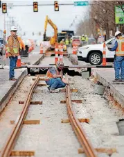  ?? [PHOTO BY JIM BECKEL, THE OKLAHOMAN] ?? Streetcar rail installati­on continues in downtown Oklahoma City. Rail installati­on is to be completed in August and work on boarding platforms, overhead wire and other components of the $131 million system is to be done by the end of November.