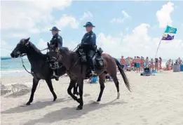  ?? JOE CAVARETTA/STAFF FILE PHOTO ?? Even animals took a hit this year when a Spring Breaker slapped the rear end of a mounted patrol and was charged with “battery on a police horse.”