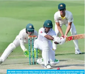  ?? — AFP ?? ABU DHABI: Pakistan cricketer Fakhar Zaman (C) plays a shot during day two of the second Test cricket match in the series between Australia and Pakistan at the Abu Dhabi Cricket Stadium in Abu Dhabi yesterday.