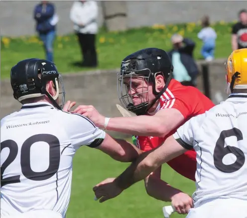  ??  ?? David Kettle, Louth is surrounded in midfield by Warwickshi­re players during the Nicky Rackard Cup game at St. Brigid’s Park.