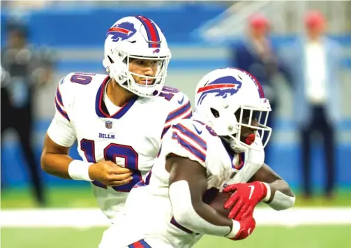  ?? AP ?? Former Bears QB Mitch Trubisky, handing off to running back Devin Singletary during the first half, was 1-for-2 for 10 yards in the Bills’ preseason win over the Lions.