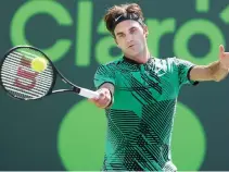  ??  ?? Roger Federer of Switzerlan­d returns a shot against Juan Martin Del Potro of Argentina during Day 8 of the Miami Open at Crandon Park Tennis Center on Monday in Key Biscayne, Florida. (AFP)