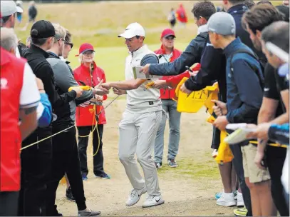  ?? Peter Morrison ?? The Associated Press Rory Mcilroy signs autographs during a practice round Wednesday ahead of the British Open, which started late Wednesday PDT in Carnoustie, Scotland. Mcilroy played his first major (as an amateur) at Carnoustie in 2007.