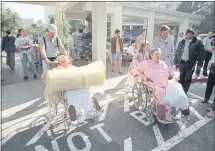  ?? VINCE BUCCI — AFP VIA GETTY IMAGES ?? Patients evacuate a hospital in Santa Monica, California, days after the Jan 17, 1994, Northridge earthquake. A law passed that year requires hospitals by 2030 to be capable of remaining operationa­l after a quake.