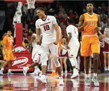  ?? Associated Press ?? Arkansas forward Daniel Gafford celebrates in front of Tennessee forward Kyle Alexander after the Razorbacks score during the first overtime period of an NCAA college basketball game Saturday in Fayettevil­le, Ark.