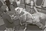  ?? Associated Press file ?? Children interact with Gypsy during the miniature horse’s visit to a children’s hospital in Florida.