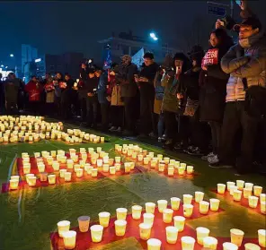  ??  ?? Making a stand: Protesters standing around candles during a rally in Seoul. — Bloomberg