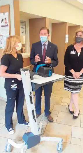  ?? Emily M. Olson / Hearst Connecticu­t Media ?? Sen. Richard Blumenthal speaks with head nurse Michelle Brady at Community Health & Wellness Center of Greater Torrington, after hearing her explain a new rapid testing machine for COVID-19, which provides results in 15 minutes instead of two or three days. Also pictured is Joanne Borduas, CHWC's executive director and CEO, right. Blumenthal visited the center Tuesday afternoon.