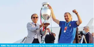  ??  ?? ROME: This handout picture taken and released by the Aereoporti Di Roma (A.D.R.) yesterday shows Italian coach Roberto Mancini (left) and Giorgio Chiellini holding the European Championsh­ip trophy after Italy won the Euro 2020 final football match between Italy and England, as they arrive at Rome’s Fiumicino airport in Rome. —AFP