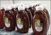  ??  ?? Honey harvested from the hives of Elvin Bates is, as the label says, pure and natural. Bates was selling his honey at a homesteadi­ng conference in Rison on April 1. He has been interested in bees and honey since he was 8 years old, he says.