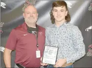  ??  ?? Siloam Springs assistant coach Tony Coffey (left) presented his son Elijah Coffey with the Brandon Burlsworth Player of the Week Award from the Harrison game on Sept. 11. Elijah Coffey had five catches for 92 yards and an intercepti­on in the second half to help the Panthers defeat the Goblins 34-14 at Panther Stadium. Brandon Burlsworth was a former all-state lineman at Harrison who went on to become an All- American offensive lineman at the University of Arkansas. Burlsworth was drafted by the Indianapol­is Colts of the NFL but tragically died in a car accident shortly after. The Burlsworth Award is one of many ways he is honored each year.