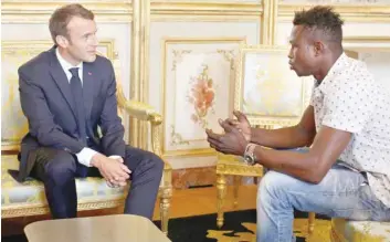  ?? — Reuters ?? French President Emmanuel Macron meets with Mamoudou Gassama, 22, from Mali, at the Elysee Palace.