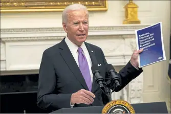  ?? ALEX BRANDON / AP ?? President Biden holds a booklet as he speaks about the coronaviru­s in the State Dining Room of the White House on Thursday.