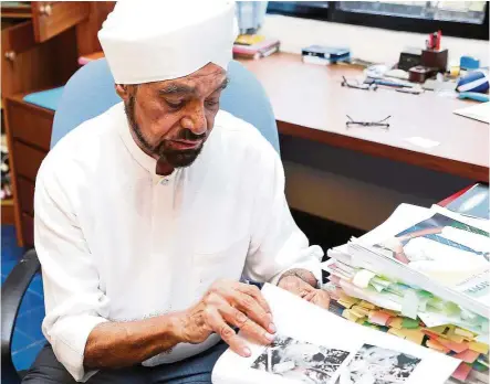  ??  ?? Dr Sambhi at home, leafing through the pages of the draft of his book. — Photos: EBBY SAIFUL/The Star