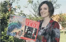  ??  ?? St Catherine’s shop manager Amity Dunn with some of the donated items.