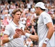  ?? AP/GLYN KIRK ?? Kevin Anderson (left) of South Africa defeated American John Isner in the men’s Wimbledon semifinals Friday in the longest match ever at Centre Court. Anderson won the fifth set 26-24.