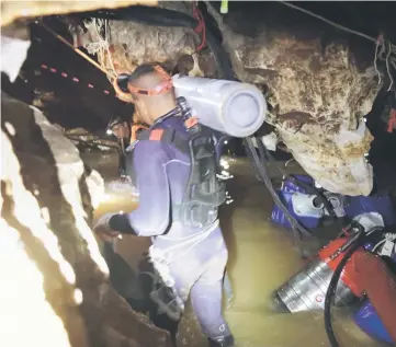  ??  ?? This undated handout photo taken recently and released by the Royal Thai Navy shows a group of Thai Navy divers in Tham Long cave during rescue operations for the 12 boys and their football team coach trapped in the cave at Khun Nam Nang Non Forest...