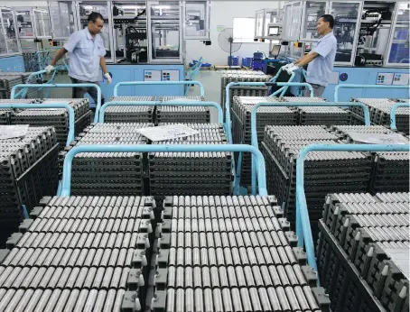 ?? CHINATOPIX VIA AP ?? Workers transfer lithium-ion batteries in a factory in Taizhou in east China’s Jiangsu province last month. China’s shipments to the U.S. rose 13 per cent in July from a year earlier, to US$41.5 billion, as the U.S.’s extra 25-per-cent tariffs on...