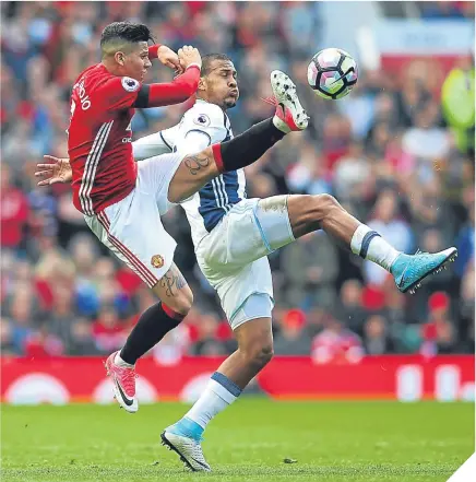  ??  ?? ■ United defender Marcos Rojo attempts to clear from West Brom substitute Jose Rondon.