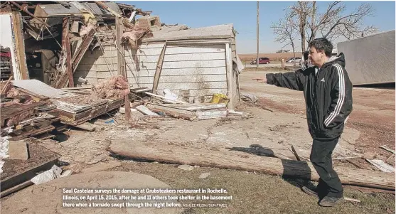  ?? ASHLEE REZIN/SUN-TIMES ?? Saul Castelan surveys the damage at Grubsteake­rs restaurant in Rochelle, Illinois, on April 15, 2015, after he and 11 others took shelter in the basement there when a tornado swept through the night before.