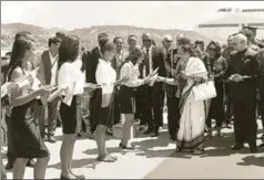  ?? PTI ?? President Ram Nath Kovind looks on as First Lady Savita Kovind offers sweets to students during their ceremonial welcome on his arrival in Madagascar, March 14