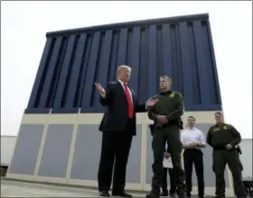  ?? EVAN VUCCI — THE ASSOCIATED PRESS ?? President Donald Trump reviews border wall prototypes, Tuesday in San Diego. During the visit Trump said, “It will save thousands and thousands of lives, save taxpayers hundreds of billions of dollars by reducing crime, drug flow, welfare fraud and...