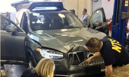  ?? ?? US National Transporta­tion Safety Board investigat­ors examine a self-driving Uber vehicle involved in a fatal accident in Tempe, Arizona, on 20 March 2018. Photograph: Reuters