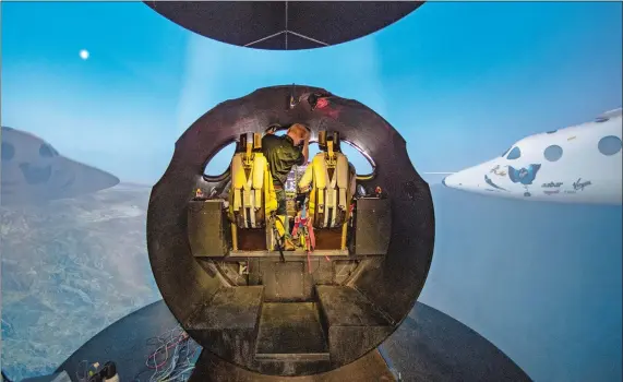  ?? JONATHAN NEWTON/ WASHINGTON POST ?? Dave Mackay, chief pilot for Virgin Galactic, climbs in the simulator for a test flight at the Virgin Galactic headquarte­rs last month in Mojave, Calif.