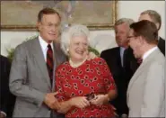  ?? MARCY NIGHSWANDE­R — THE ASSOCIATED PRESS FILE ?? Former first lady Barbara Bush, center, laughs with Sen. Paul Simon, D-Ill, right, after receiving the pen President George Bush, left, used to sign the National Literacy Act of 1991 during a ceremony at the White House in Washington. Promoting...