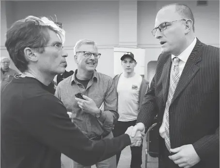  ?? DAN JANISSE ?? Matt Marchand, left, congratula­tes re-elected Windsor Mayor Drew Dilkens at the St. Clair Centre for the Arts after his re-election.