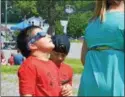  ??  ?? Hundreds attend the Great American Solar Eclipse viewing party at the future site of the Oneida Public Library on Monday.