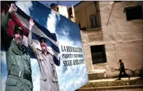  ?? PICTURE: AP ?? A man walks next to a poster of Fidel Castro and Cuba’s ex-president Raul Castro, in Havana, Cuba. Cuba’s legislatur­e yesterday elected Miguel Mario Diaz-Canel as successor to Castro.