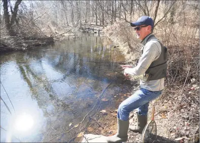  ?? Brian A. Pounds / Hearst Connecticu­t Media ?? A fisherman tries out a new fishing spot on the Mill River in Fairfield on Sunday, March 21. State officials will debate a plan to divert 14.2M gallons a day from the Greater Bridgeport System to the Southwest Regional Pipeline, which may impact the Mill River, opponents say.