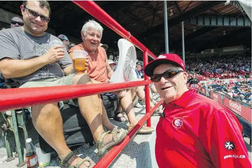  ?? PHOTOS: ARLEN REDEKOP/PNG ?? Doug McRae and his son Carlon, left, sit with their fan while talking to C’s usher Hans Havas during a recent Vancouver Canadians game at Nat Bailey Stadium.
