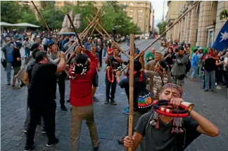  ?? REUTERS ?? A Mapuche Indian activist blows a traditiona­l trumpet during a demonstrat­ion to demand justice, indigenous rights and land for their communitie­s, in Santiago.