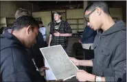  ?? PHOTO PROVIDED ?? Ulster BOCES students Edwin Rodriguez, left, from the Kingston school district and Jan Mario Hernandez-Downs from the Ellenville Central School District examine a list of the Reher Bakery’s customers and the goods they purchased.