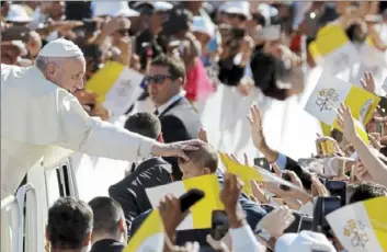  ?? Andrew Medichin/Associated Press ?? Pope Francis blesses a child as he arrives in the Sheikh Zayed Sports City Stadium to celebrate a mass Tuesday in Abu Dhabi, United Arab Emirates. The pontiff ministered on Tuesday to the thriving Catholic community in the United Arab Emirates as he concluded his historic visit to the Arabian Peninsula with the first-ever papal Mass there.