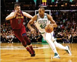  ?? MADDIE MEYER / GETTY IMAGES ?? Al Horford (42) of the Boston Celtics is defended by Kevin Love of the Cleveland Cavaliers during the Eastern finals opener Sunday.