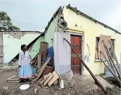  ?? Picture ALAN EASON ?? LUCKY ESCAPE: Neighbour Nompumezo Gwadiso stands next to the collapsed bedroom of Jessie Mangesi’s house outside Ntabozuko (formally Berlin). Mangesi was able to escape when the walls collapsed due to the January floods