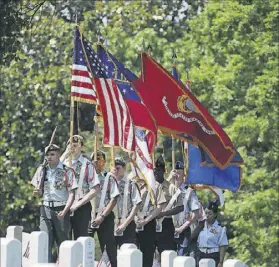  ?? CONTRIBUTE­D BY BOB ANDRES / BANDRES@AJC.COM ?? Set against a backdrop of the graves of more than 10,000 veterans from 23 states, Marietta’s Memorial Day Ceremony features patriotic music, posting of the colors, prayers, a gun salute and inspiring speakers.