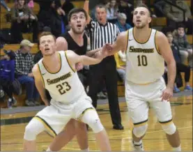  ??  ?? Skidmore College’s Pat Gallagher (23) and Edvinas (Ed) Rupkus (10) block out RPI’s Patrick Mahonsey in the first half of Saturday’s Liberty League tilt at the Williamson Center on the Skidmore College campus.