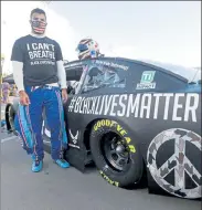  ?? AP ?? Driver Bubba Wallace waits for the start of a NASCAR Cup Series auto race in Martinsvil­le, Va. Wallace now counts Spike Lee and Demi Lovato — his admitted celebrity crush — as those loudly in his corner since he’s become the leader of NASCAR’s push for change.