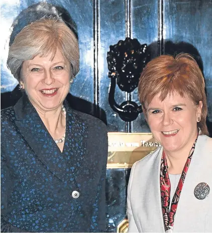  ??  ?? WARMING: Theresa May, left, and Nicola Sturgeon are all smiles ahead of yesterday’s talks at 10 Downing Street