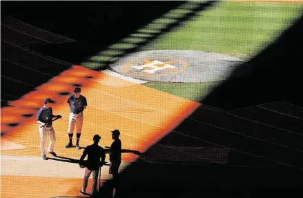  ?? Brett Coomer / Staff photograph­er ?? Astros manager A.J. Hinch, left, and first base coach Don Kelly meet on the field before the team’s workout on Monday.