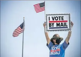  ?? Irfan Khan Los Angeles Times ?? JIMMY McGRAW demonstrat­es at a Santa Ana post office Saturday. Democrats say GOP donor John M. Barger helped the new postmaster general get hired.