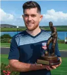  ??  ?? Ronan Murray with the Player of the Month award for August