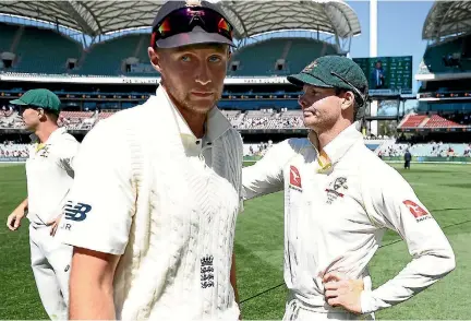  ?? PHOTO: GETTY IMAGES ?? England captain Joe Root, centre, congratula­tes Steve Smith after Australia’s win in the second test in Adelaide.