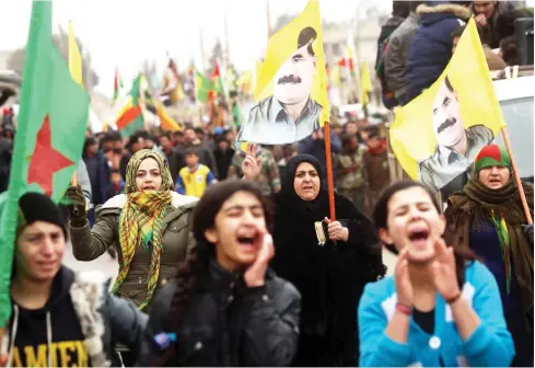  ??  ?? Syrian Kurds carry portraits depicting jailed founding member and leader of the Kurdistan Workers’ Party (PKK) Abdullah Ocalan as they march during a protest in support of Afrin in the northern Syrian town of Jawadiyah. (AFP)